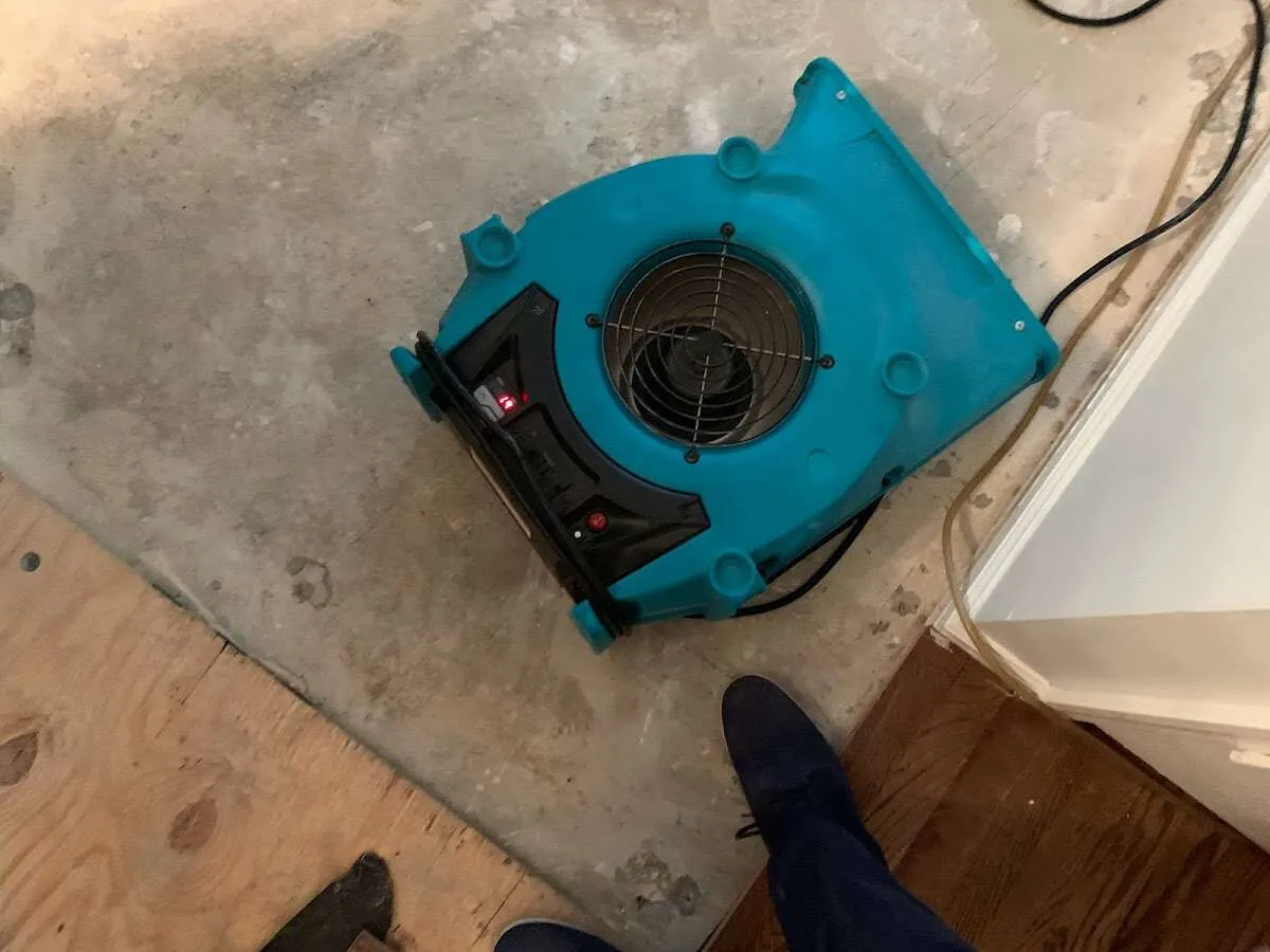Air mover drying subfloor during Commercial Water Damage Restoration in Macclenny